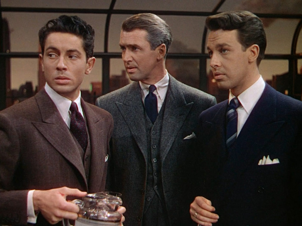  Medium close-up of Farley Granger, Jimmy Stewart, and John Dall standing together in the movie Rope.