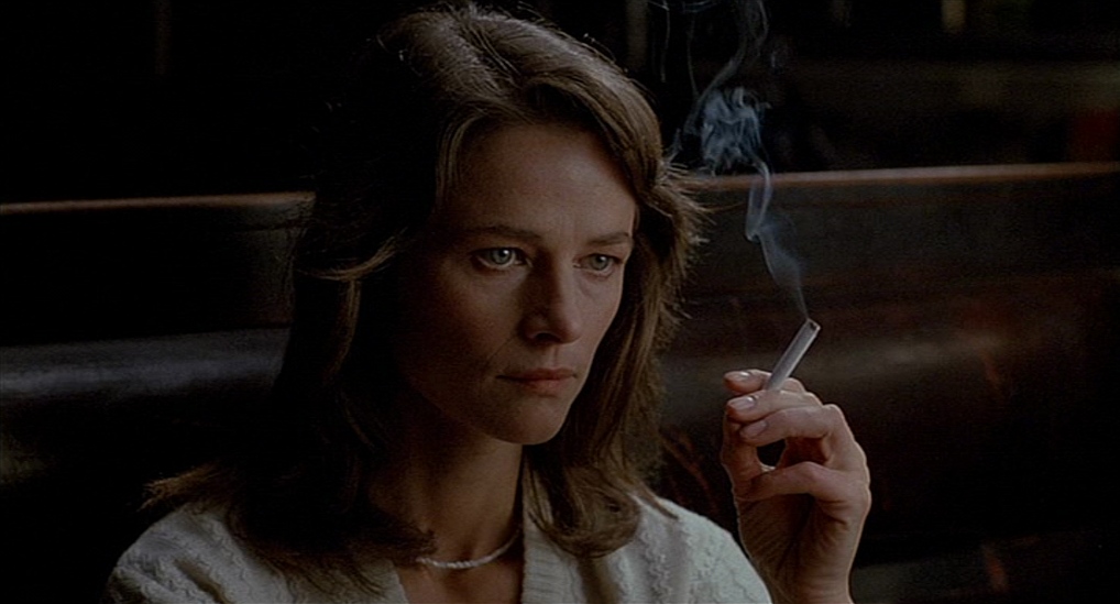 Charlotte Rampling as Laura Fischer smoking a cigarette.