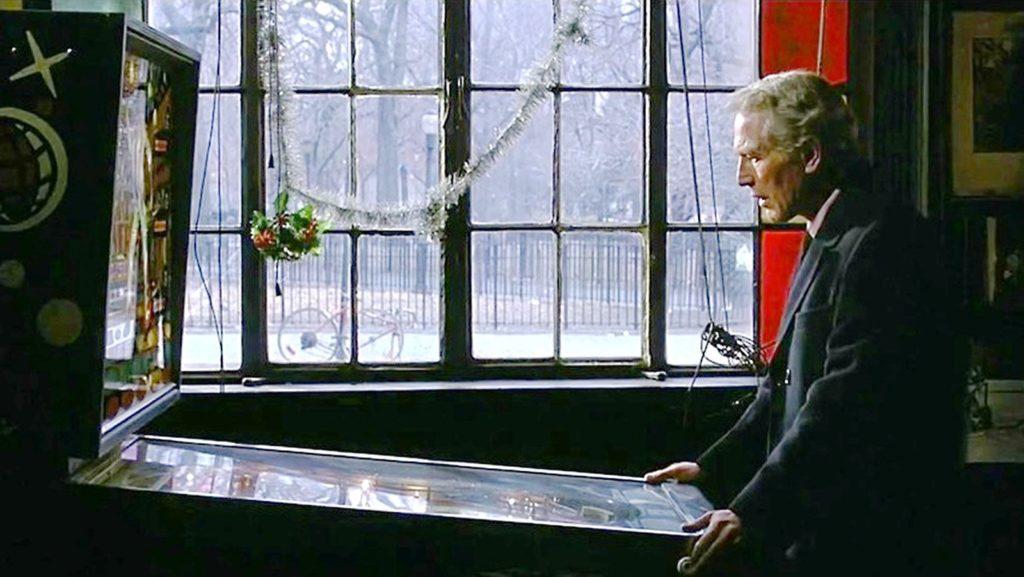 Paul Newman as Frank Galvin joylessly playing pinball.