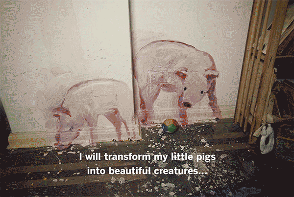 Two pigs painted onto a wall, playing with a colored ball.