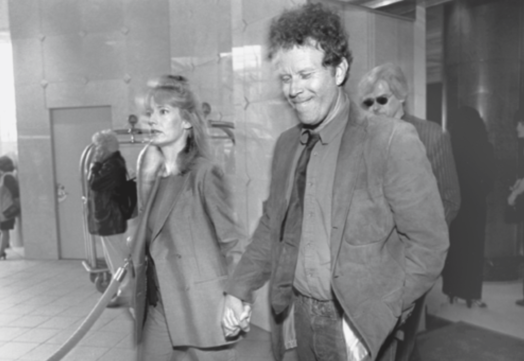 Kathleen Brennan and Tom hold hands as they walk through a hotel lobby, on their way to the Peter J, Owens gala tribute to Nicolas Cage in San Francisco