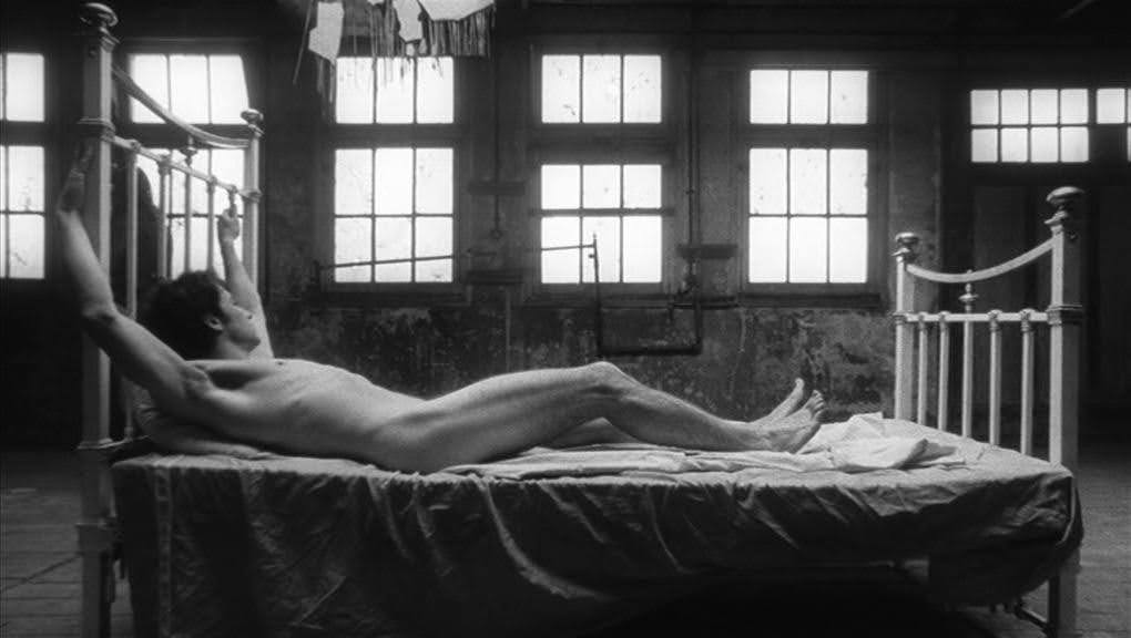 J.R. (Harvey Keitel) stretched naked across his bed, looking out the window of his warehouse apartment posed vaguely as though he’s being crucified, from Who’s That Knocking at My Door? (1967)