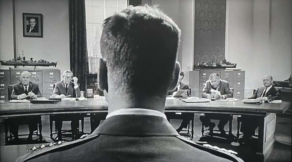 Air Force General James Mattoon Scott (Burt Lancaster) awaits questions from the Senate Armed Services Committee in John Frankenheimer’s Seven Days in May (1964).