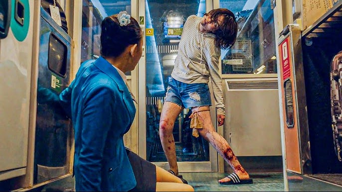 Image of well-dressed train attendant confronted by bloody zombie