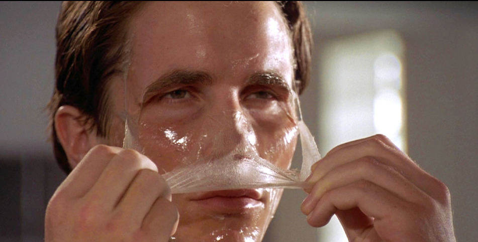 Patrick Bateman peels off a face mask