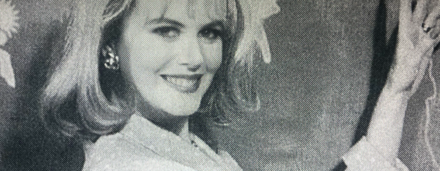 A black and white newspaper photo of Suzanne, portrayed by Nicole Kidman, happily reporting the weather for a television news broadcast.