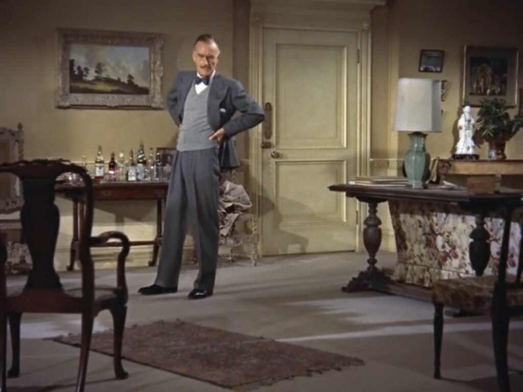  a white man standing and looking around a living room