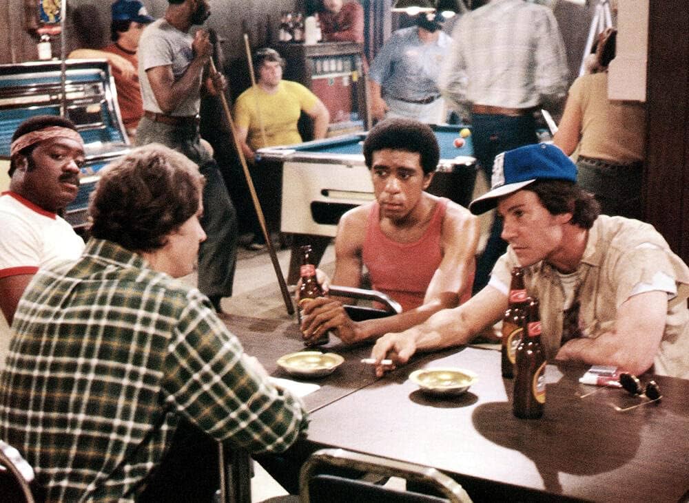 Yaphet Kotto, Richard Pryor, Harvey Keitel, and Cliff De Young gather at a bar in Blue Collar