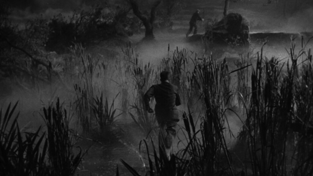 A man chases after a cake thief through a misty fen at night, during a bombing raid. Both men are seen from behind.