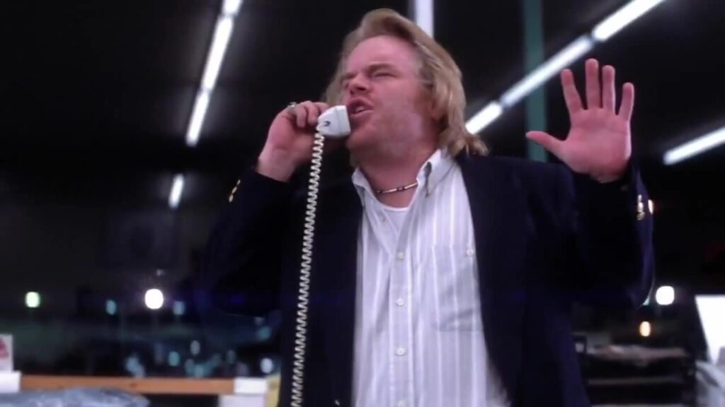 Philip Seymour Hoffman as Dean Trumbell yelling on phone.